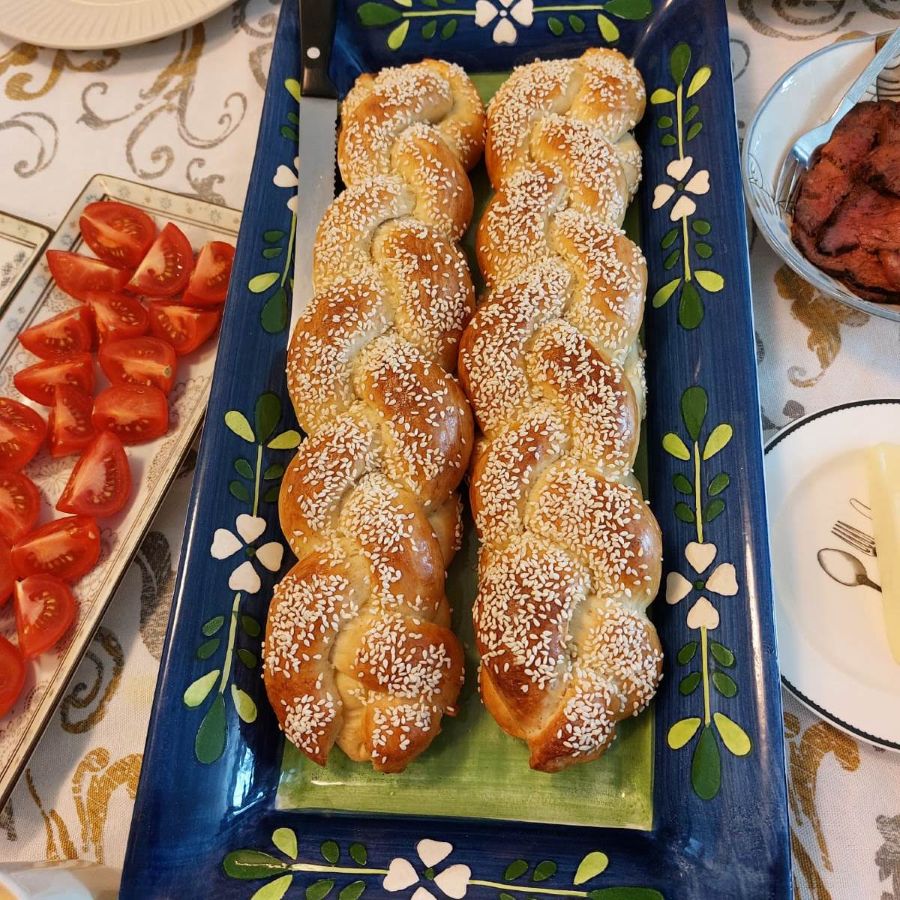 Four-strand Israeli braided challah topped with sesame seeds