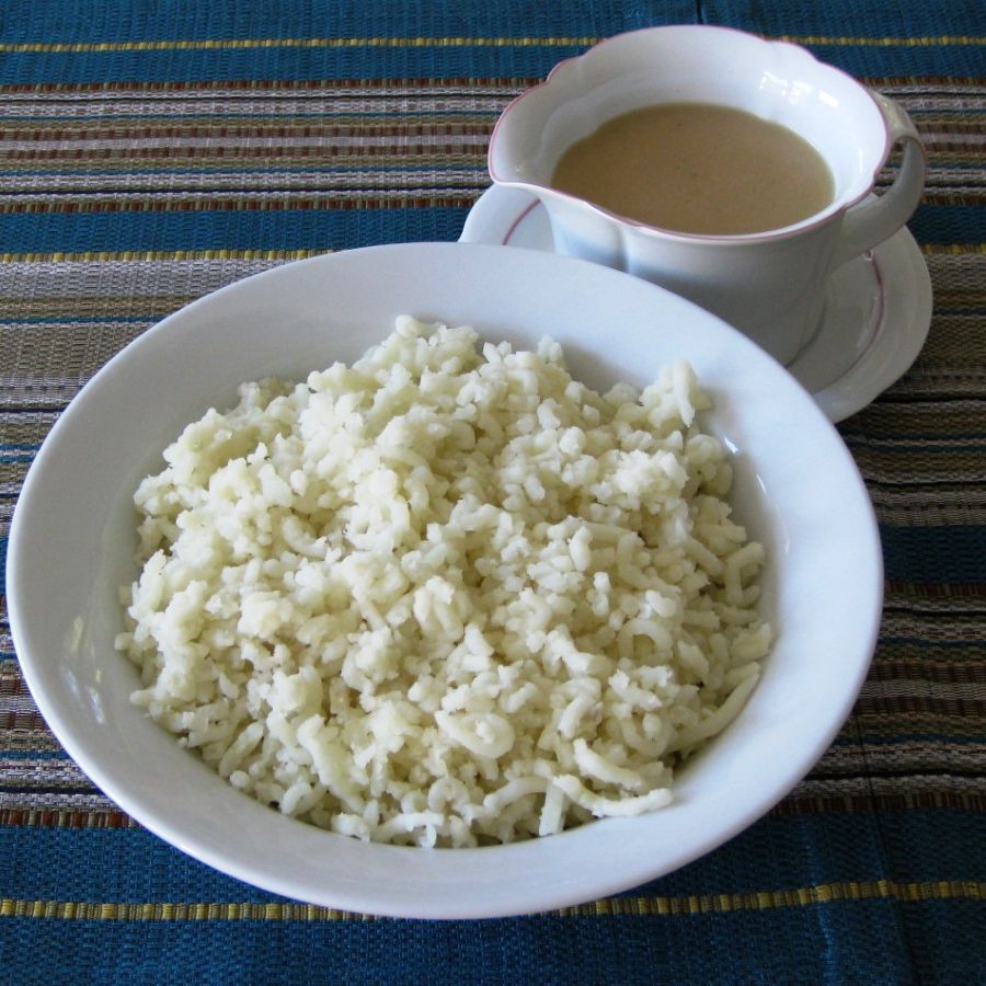 Mashed potatoes with golden fried onions and savory turkey gravy